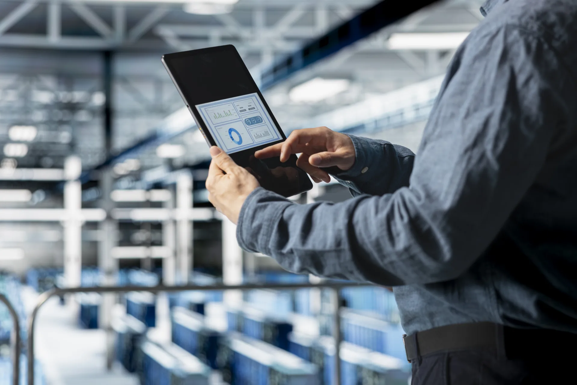 Close up of server room employee analyzing equipment metrics on device screen close up of server room employee analyzing equipment metrics on device screen